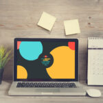 Laptop Opened on a Wooden Desk in Front View Mockup