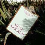 Laying Menu Between Flowers Mockup