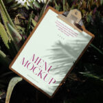 Laying Menu Between Flowers Mockup