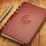 Leather Notebook Cover with Emboss Logo Mockup on Wooden Surface