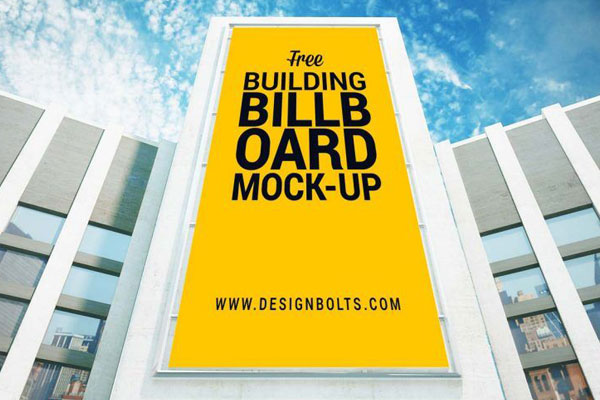 Low-Angle View Mockup of a Vertical Billboard on Building