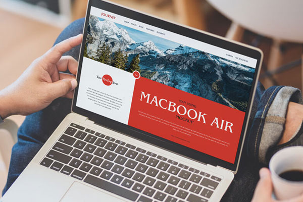MacBook Air Mockup Opened on the Lap of a Man at the 3\4 Angle View