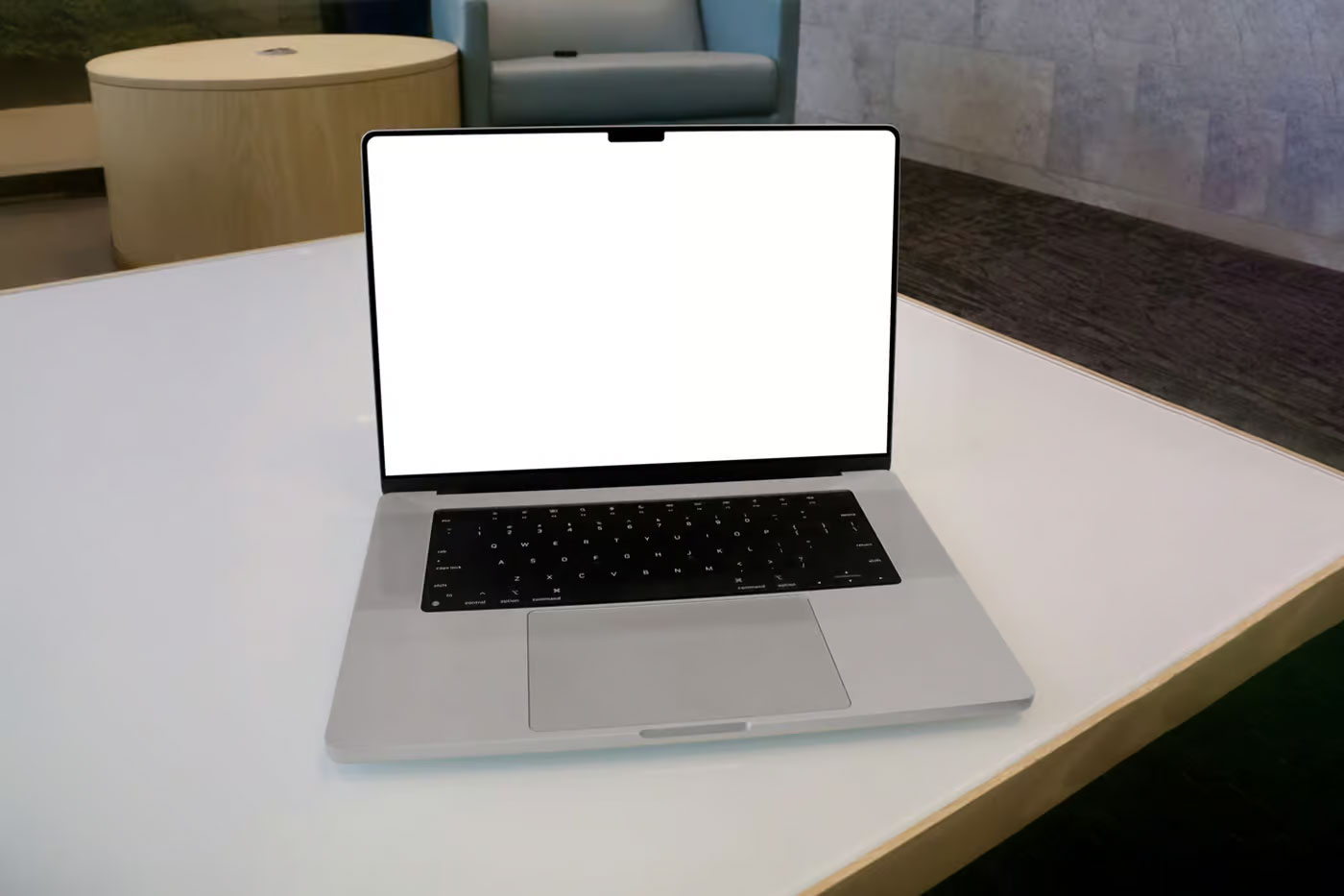 Free MacBook Pro in Office Mockup PSD Template