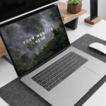 MacBook Pro Side View on Table with Similar Items Mockup