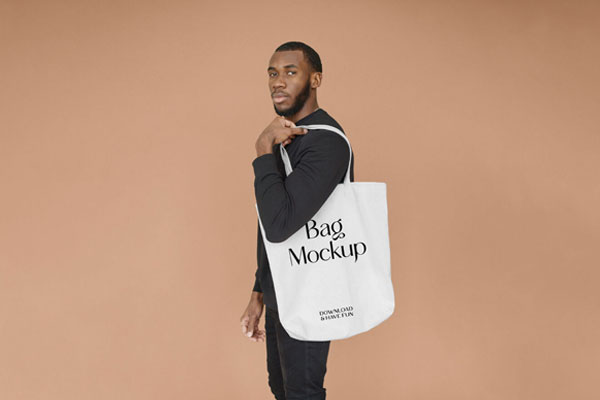 Man Carrying a Large Canvas Bag on His Shoulder Mockup
