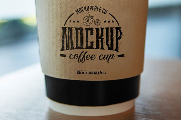 Medium Size Coffee Cup on the Table Mockup