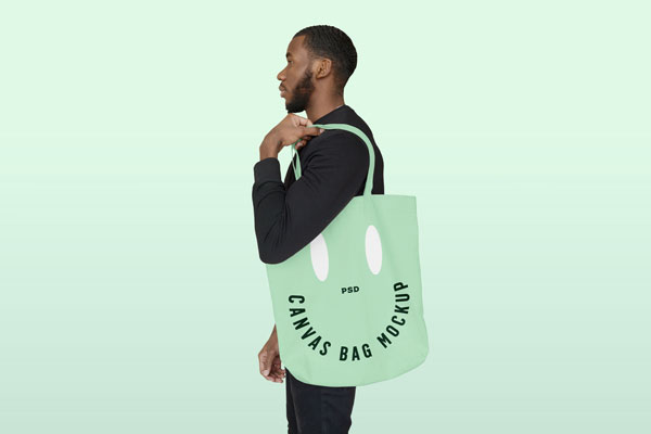 Men Holding Big Canvas Bag Mockup