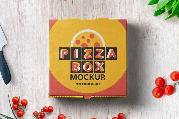 Mockup Displaying Top View of a Pizza Box on Wooden Surface Beside Cherry Tomatoes