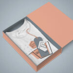 Mockup Featuring a Folded T-Shirt in the Packaging Box in Perspective