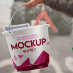 Mockup Featuring a Hand Holding a Bucket