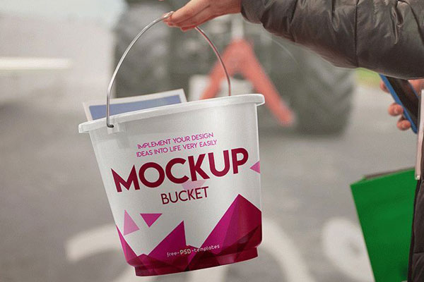 Mockup Featuring a Hand Holding a Bucket