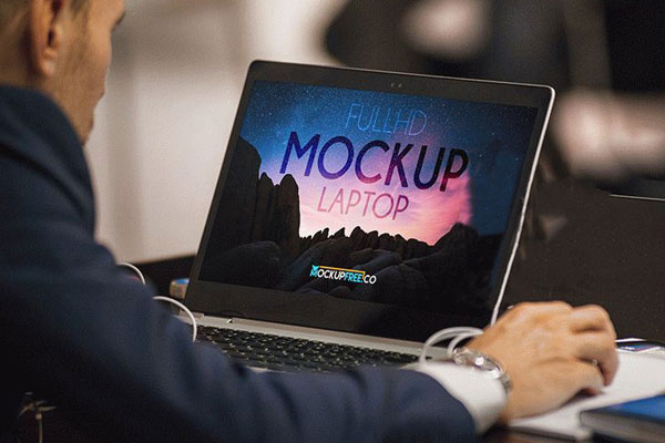 Mockup Featuring a Man Working on Laptop