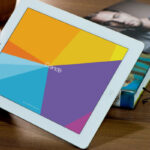 Mockup Featuring Hand Holding iPad on Wooden Table