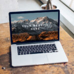 Mockup Featuring Open MacBook Pro on a Wooden Desk