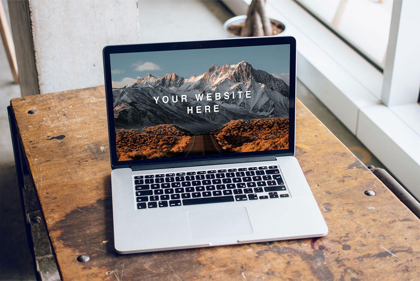 Mockup Featuring Open MacBook Pro on a Wooden Desk FREE PSD
