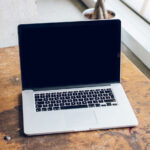Mockup Featuring Open MacBook Pro on a Wooden Desk