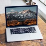 Mockup Featuring Open MacBook Pro on a Wooden Desk