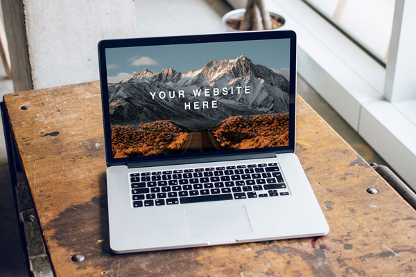 Mockup Featuring Open MacBook Pro on a Wooden Desk