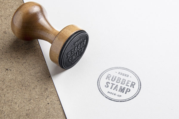Mockup Featuring Rubber Stamp and Marked Paper on Wooden Texture
