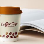 Mockup Featuring Standing Paper Coffee Cup with Book at Background
