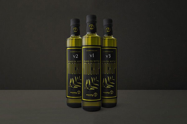 Mockup Featuring Three Slim, Glass Oil Bottles in Front View