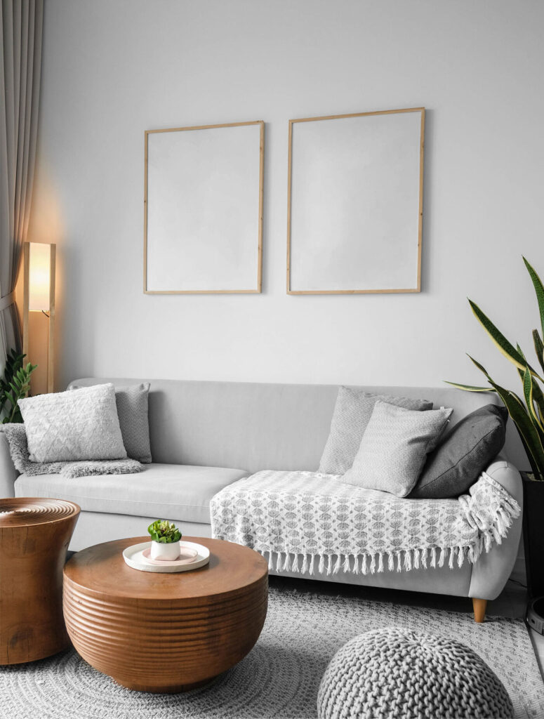 Mockup Featuring Two Posters Hanging Above Couch in Living Room