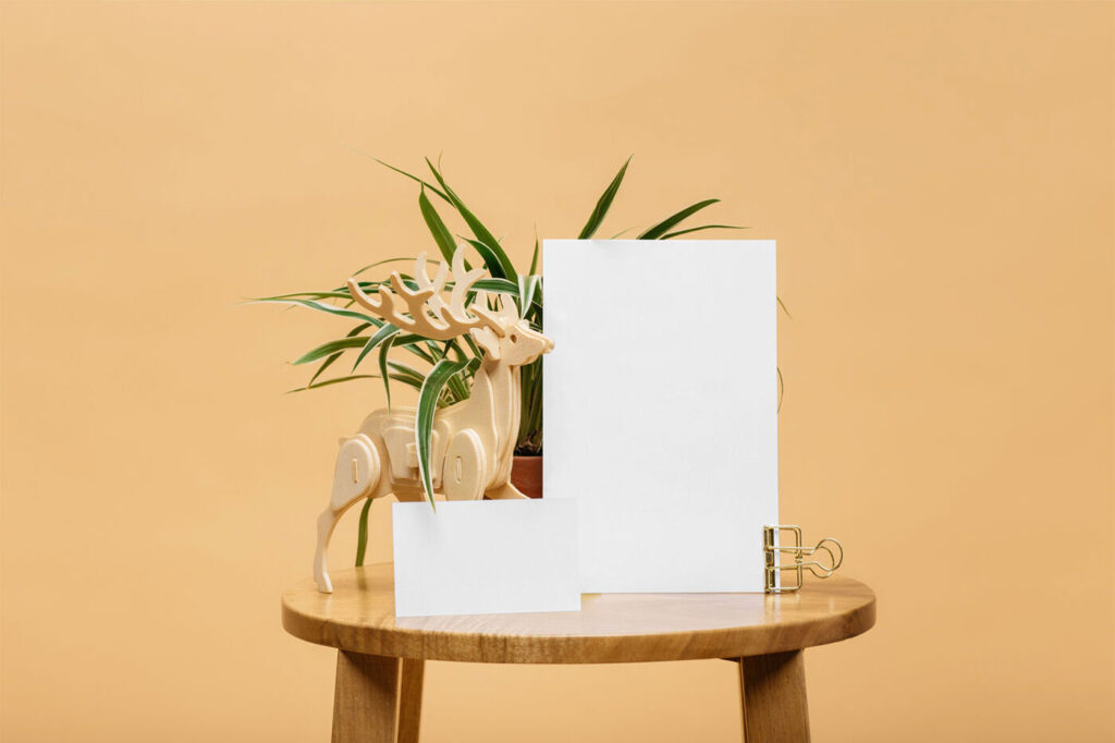 Mockup Featuring Two Sized Cards on Wooden Round Table