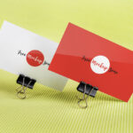 Mockup of 2 Business Cards Held by Binder Clips