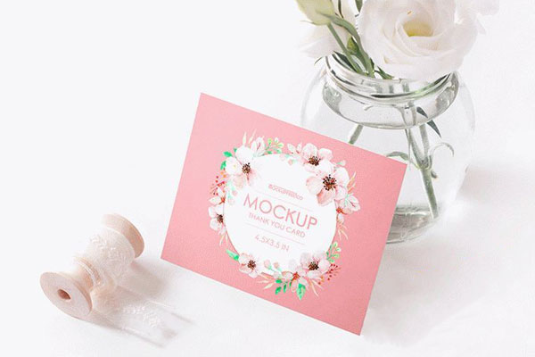 Mockup of a Thank You Card Decorated with Flowers and a Spool
