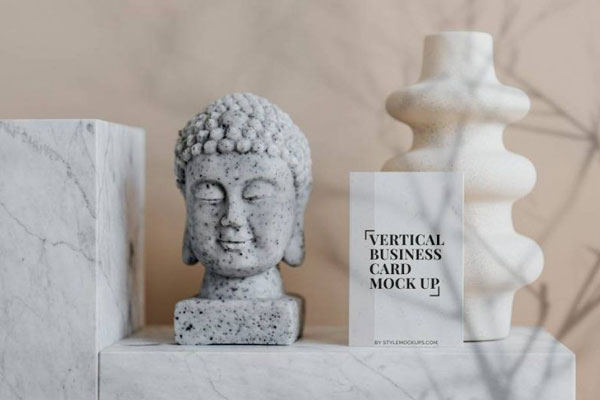 Mockup of a Vertical Business Card in Front View Featuring a Buddha Bust