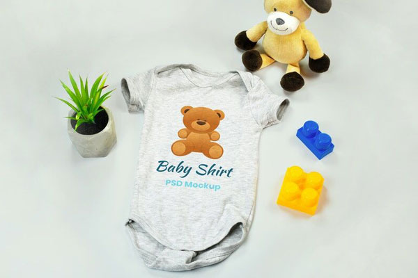 Mockup of Baby Onesie with Teddy Bear and Blocks toys