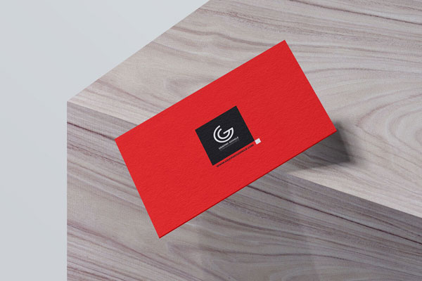Mockup of Business Card Falling off a Wooden Box in Perspective