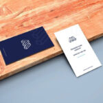 Mockup of Two Business Cards in Perspective Featuring a Wooden Board