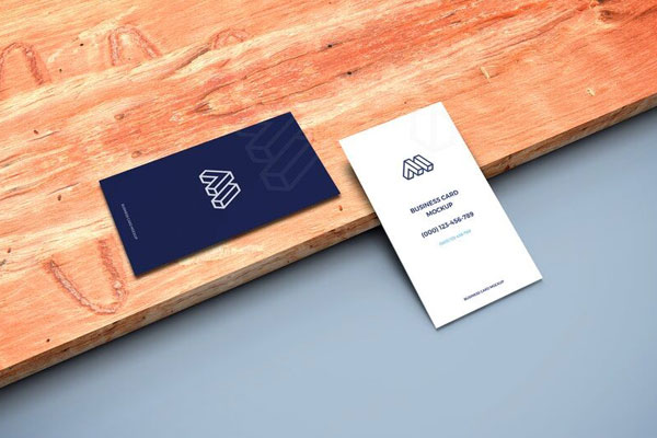 Mockup of Two Business Cards in Perspective Featuring a Wooden Board