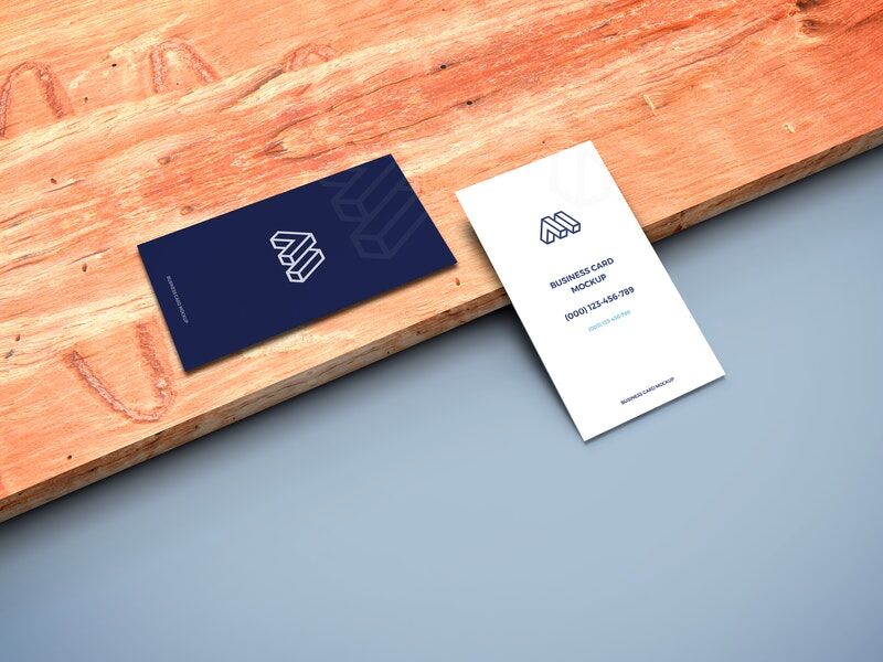 Mockup of Two Business Cards in Perspective Featuring a Wooden Board