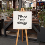Mockup Showcasing Easel Holding a Square Canvas on Outdoor Environment