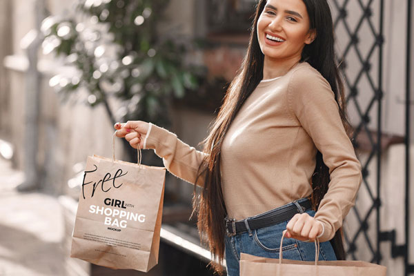 Mockup Showcasing Girl Holding Shopping Bags in Outdoor Setting