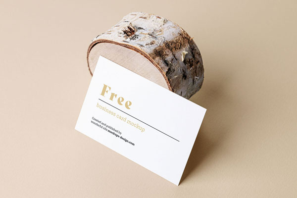 Mockup Showcasing Side View of Business Card Against Wood Trunk