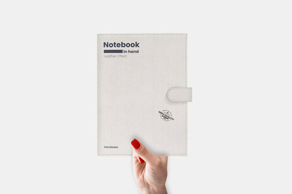 Mockup Showcasing Woman’s Hand Holding Leather Notebook