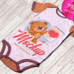 Mockup Showing a Baby Bodysuit on a Wooden Floor