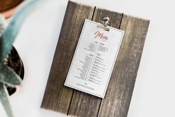 Mockup Showing a Restaurant Menu Card on a Wooden Board