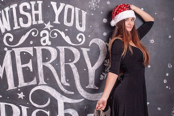 Mockup Showing a Woman Holding Christmas Shopping Bags