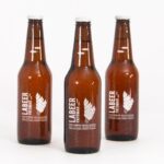 Mockup Showing Three Standing Beer Bottles with Metallic Caps