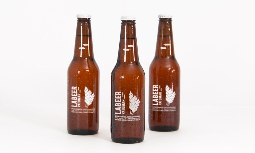 Mockup Showing Three Standing Beer Bottles with Metallic Caps