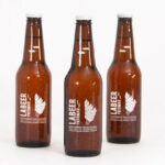 Mockup Showing Three Standing Beer Bottles with Metallic Caps