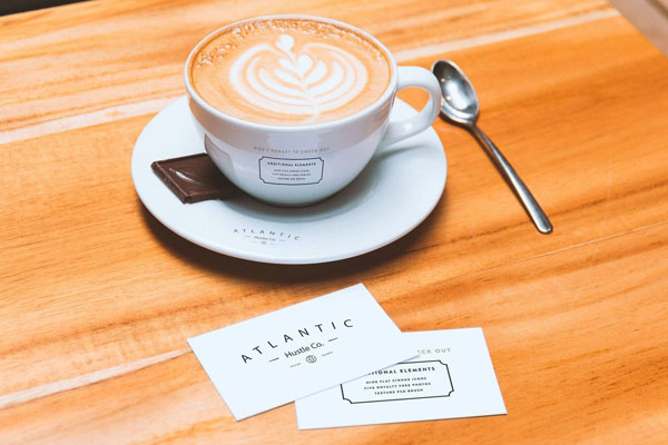 Mockup Showing Two Business Cards and Coffee Cup on Saucer
