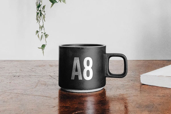 Mug on Table Mockup with a Book