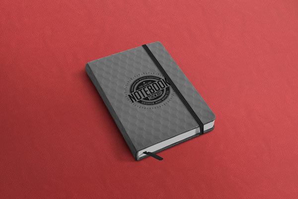Notebook Mockup Laid on the Surface in Perspective