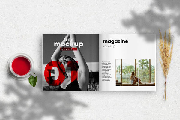 Opened Magazine Mockup Between a Cup of Tea and a Wheat Branch