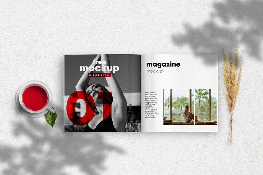 Opened Magazine Mockup Between a Cup of Tea and a Wheat Branch
